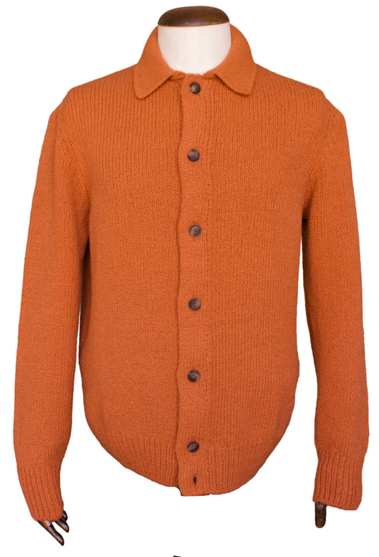 An orange knit button-up cardigan sweater displayed on a mannequin torso, white background