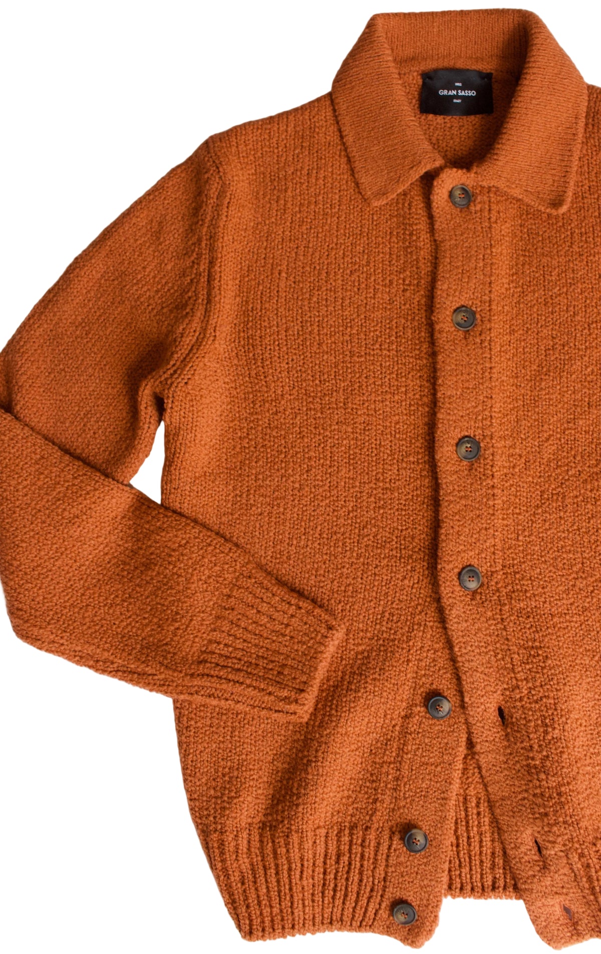 An orange knit button-up cardigan sweater with a collar, laid flat on a white surface.