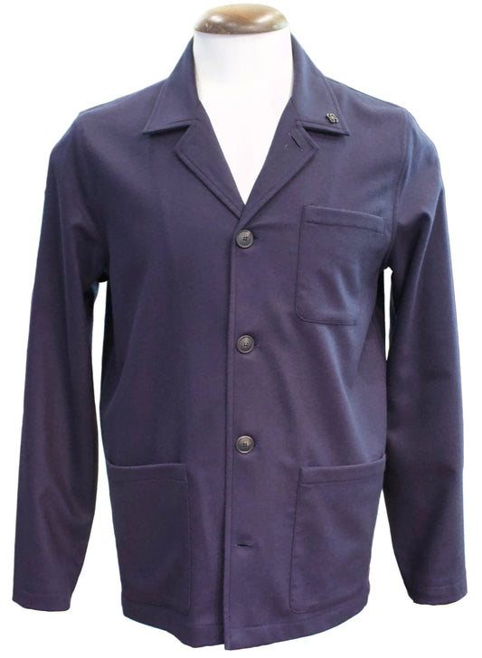 A navy long-sleeve utility jacket with a notch lapel, three-button front closure, and front patch pockets, displayed on a mannequin torso in a clothing store.