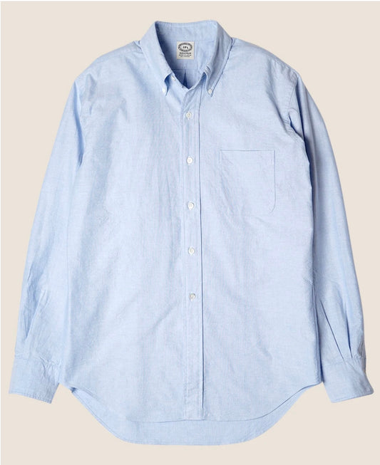 Light blue button-up shirt on a beige background