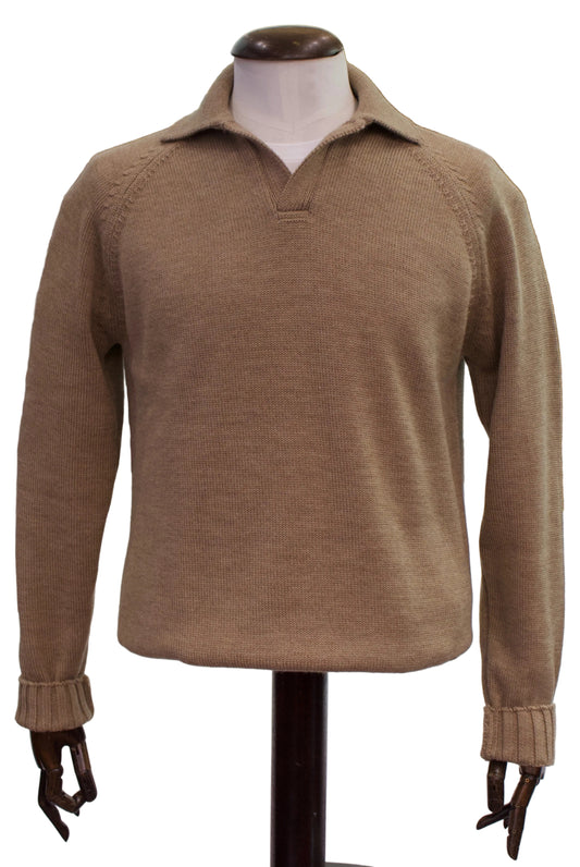 A tan knit long-sleeve polo sweater displayed on a mannequin torso with wooden hands inside a retail store.