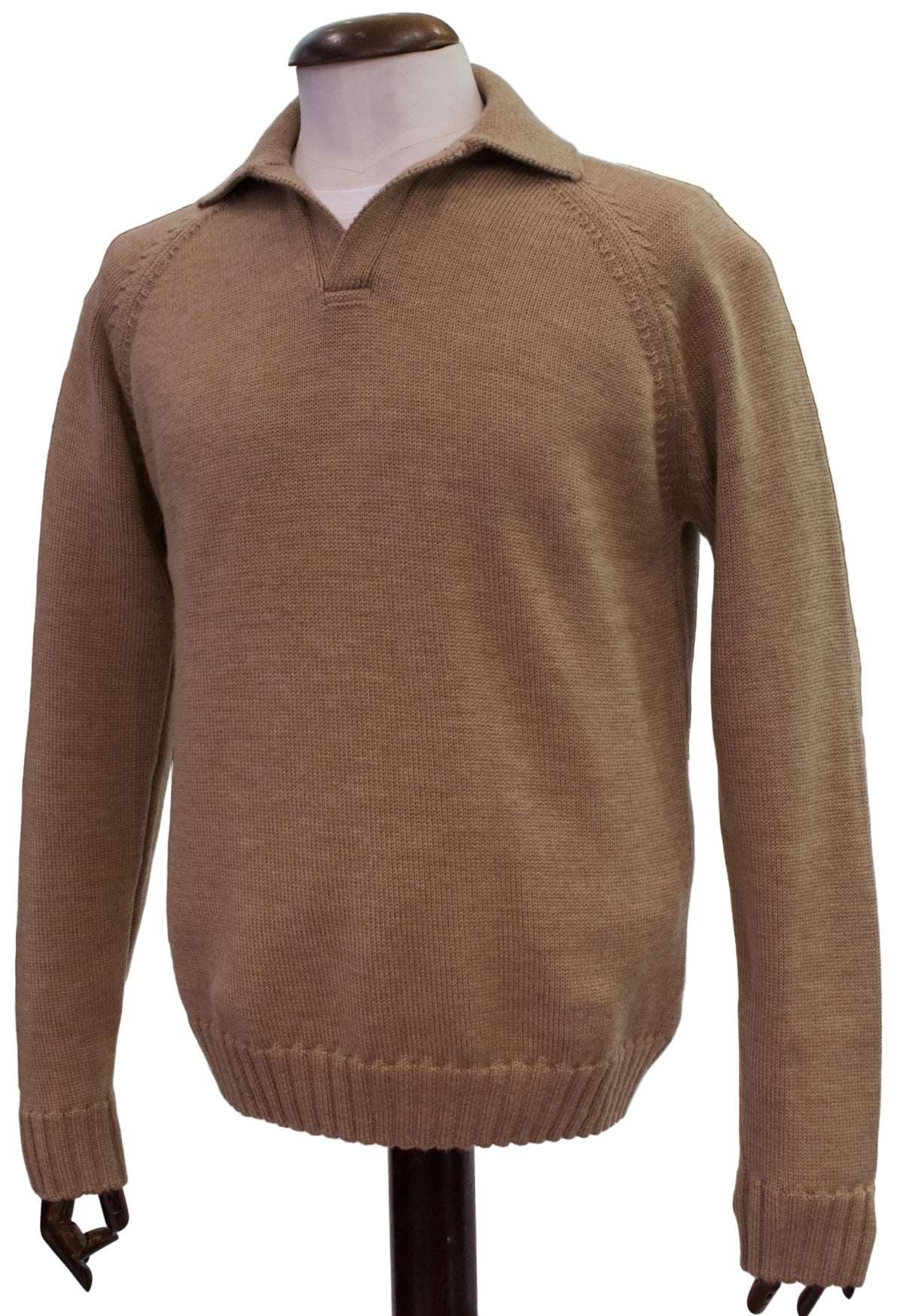 A tan knit polo-style sweater displayed on a mannequin torso in a retail store setting. The sweater has a short button placket, ribbed collar, raglan sleeves, and ribbed cuffs and hem.